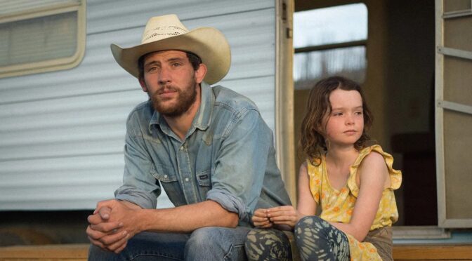 still from Rebuilding showing a man in a cowboy hat and a little girl sitting on a porch